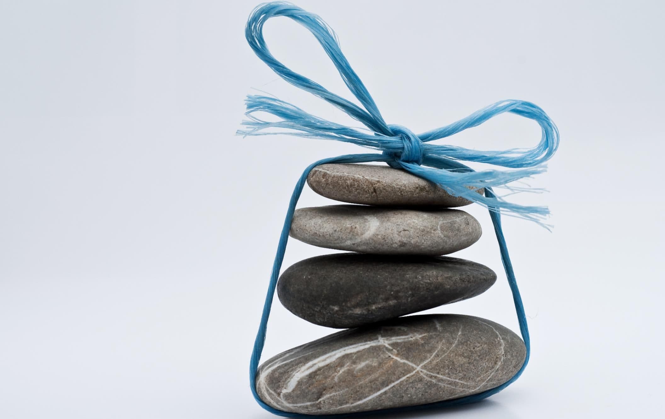 A pile of rocks tied up with a bow represents the challenge of B2B bundle pricing.
