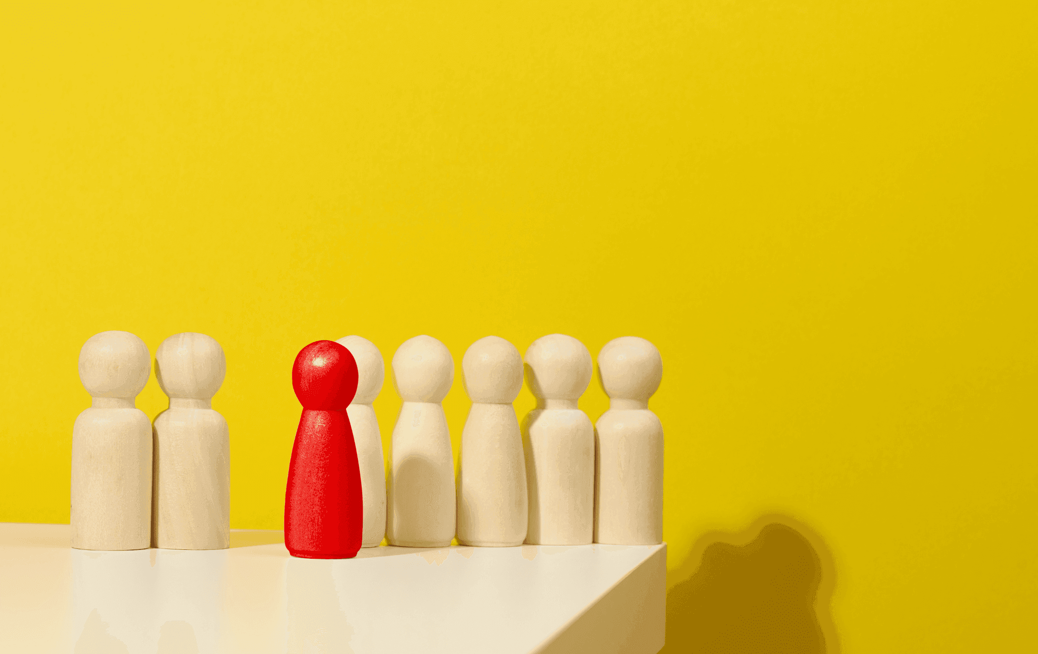 One red peg among many generic ones represents customer centricity.