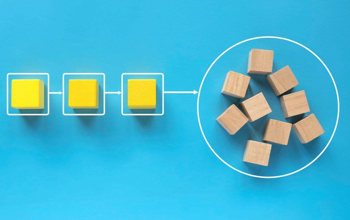 Blocks arranged in a row on a blue surface speak to the visibility brought by good B2B SaaS billing software.